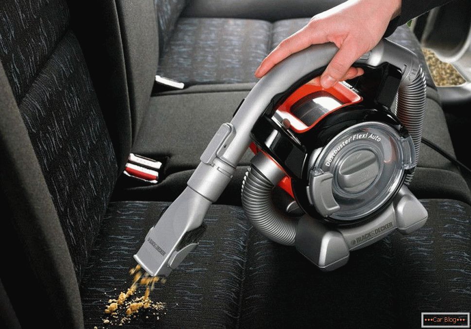 Cleaning the car with a vacuum cleaner