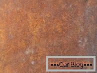 Photo of the surface manifestations of rust on the car body